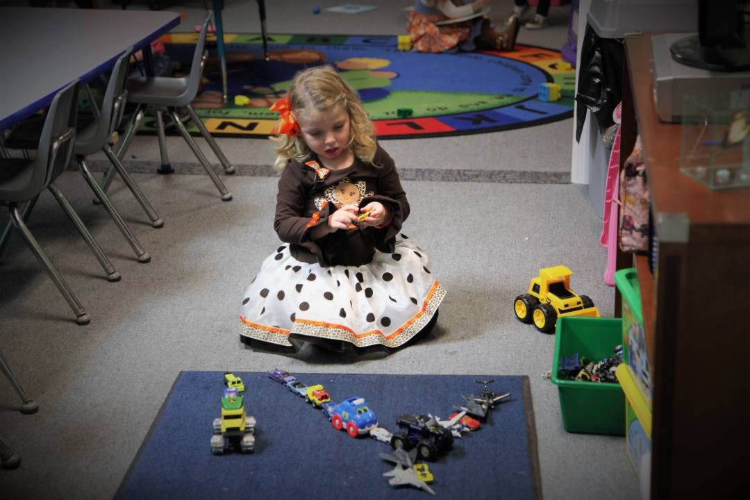 Child playing with toys on the floor