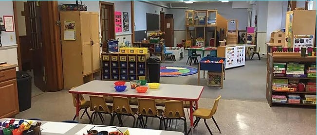 Classroom with tables, chairs, and various learning materials