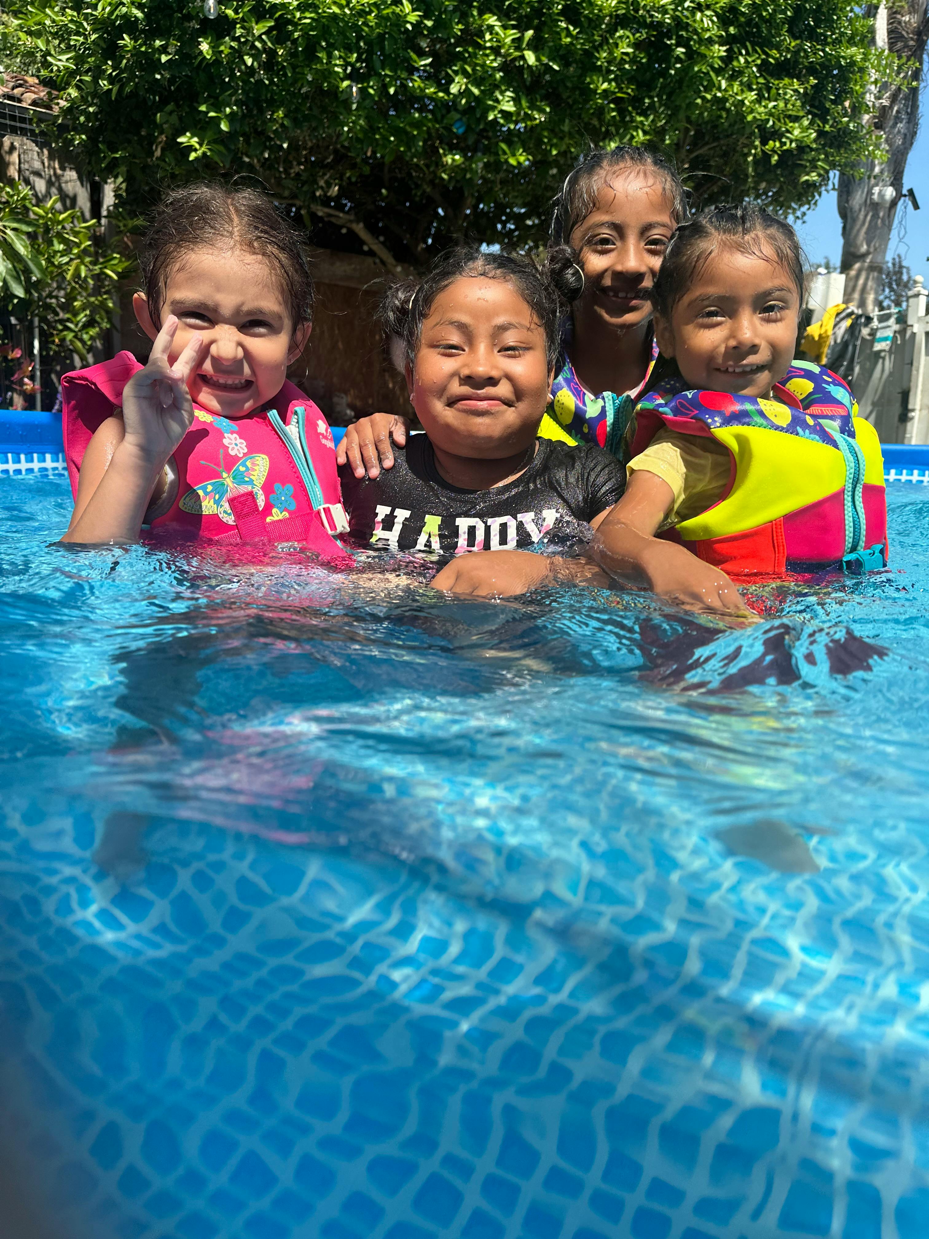 Four children in a swimming pool