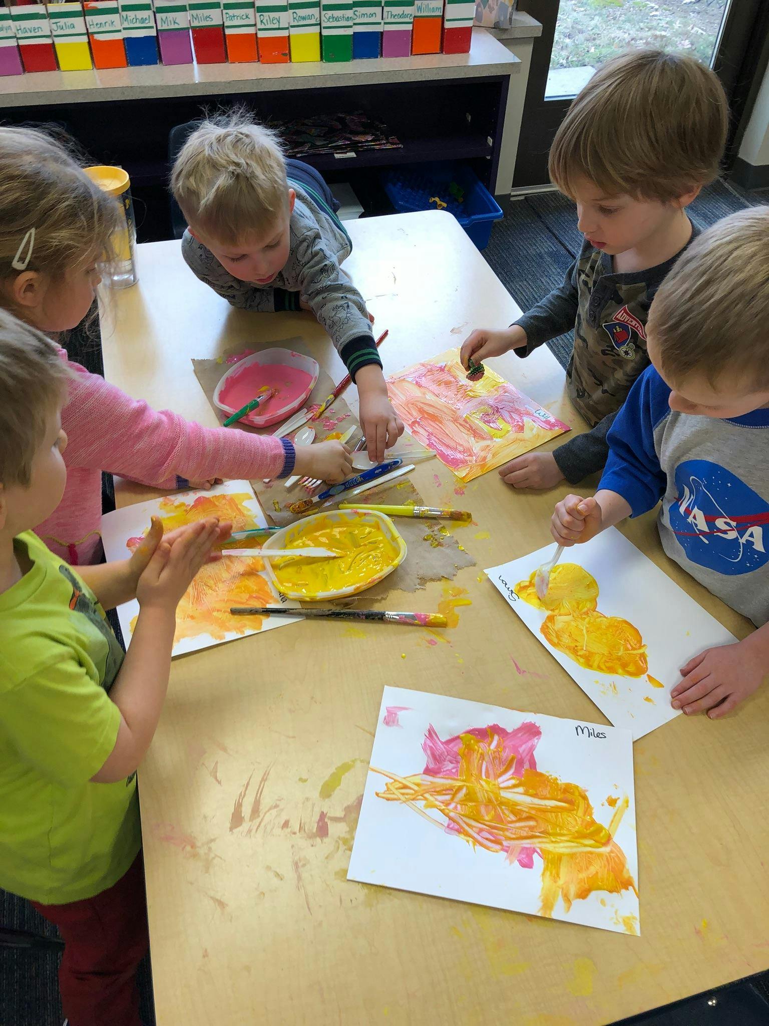 Children painting at a table