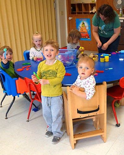 Children and an adult in a classroom