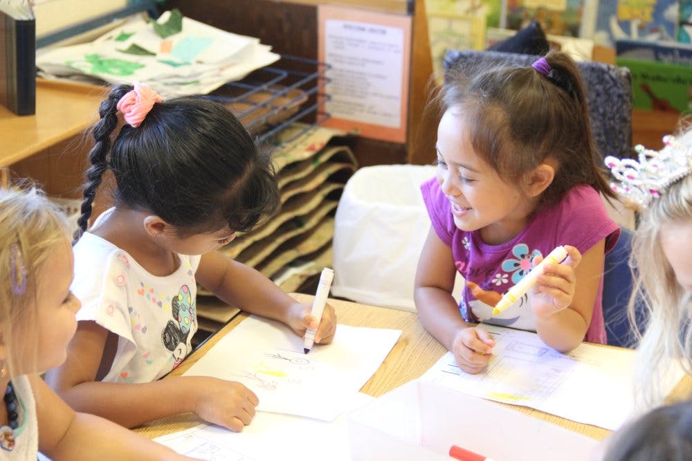 Children drawing and coloring at a table