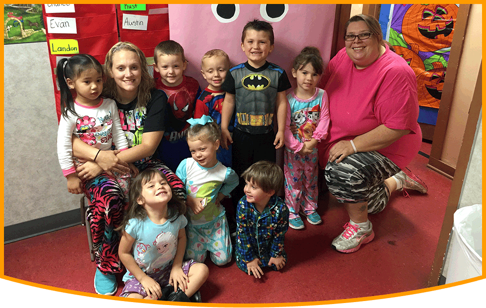 Adults and children posing for a group photo