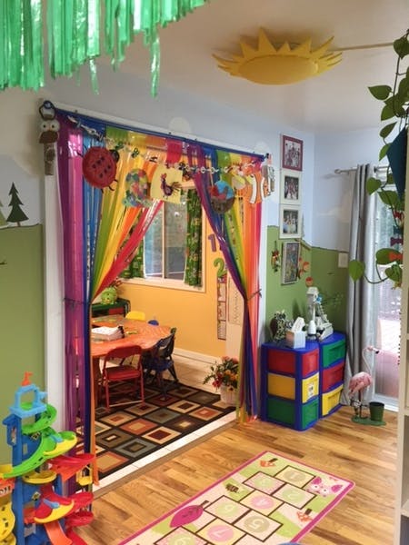 Playroom with rainbow curtains and a small table and chairs