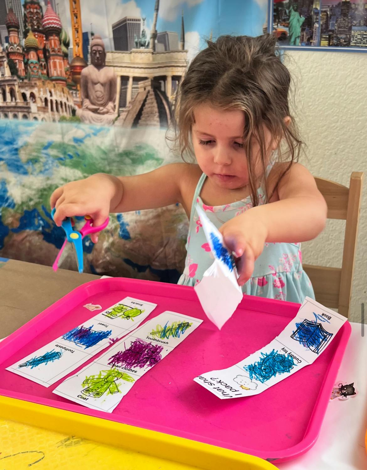 Child cutting paper with scissors