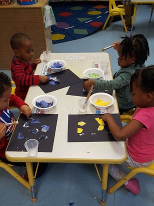 Children doing an art project at a table