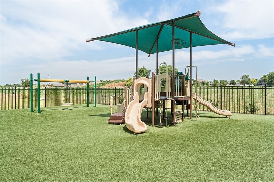 Playground with slides and a green shade canopy