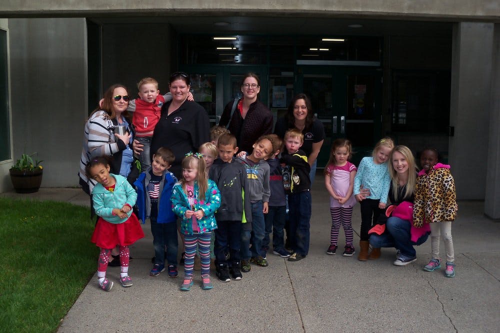 Group of adults and children standing together outdoors