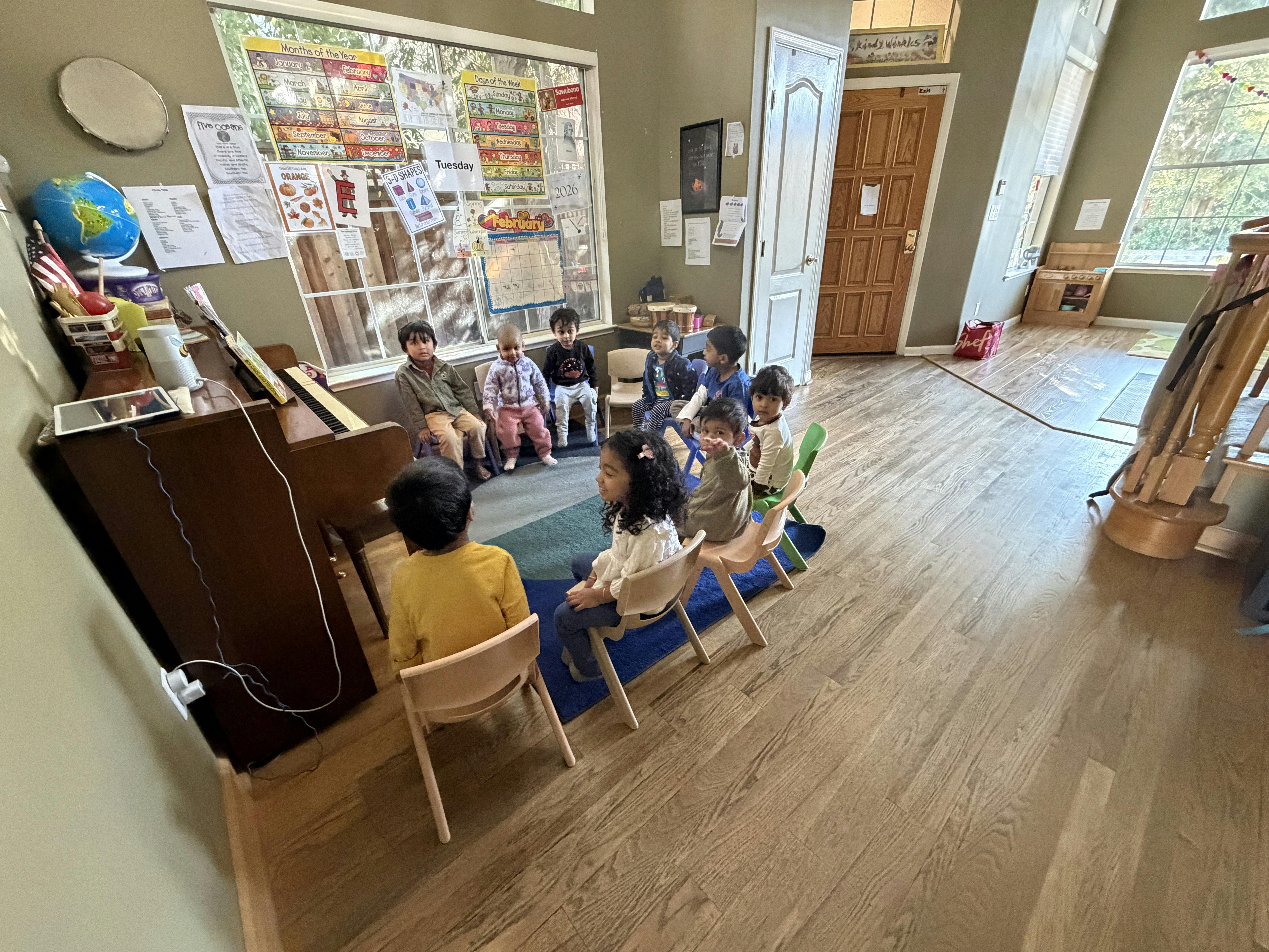 Group of children seated in a circle in a classroom