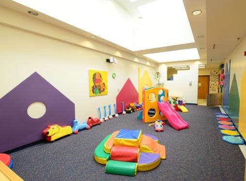 Indoor play area with soft play equipment and a slide