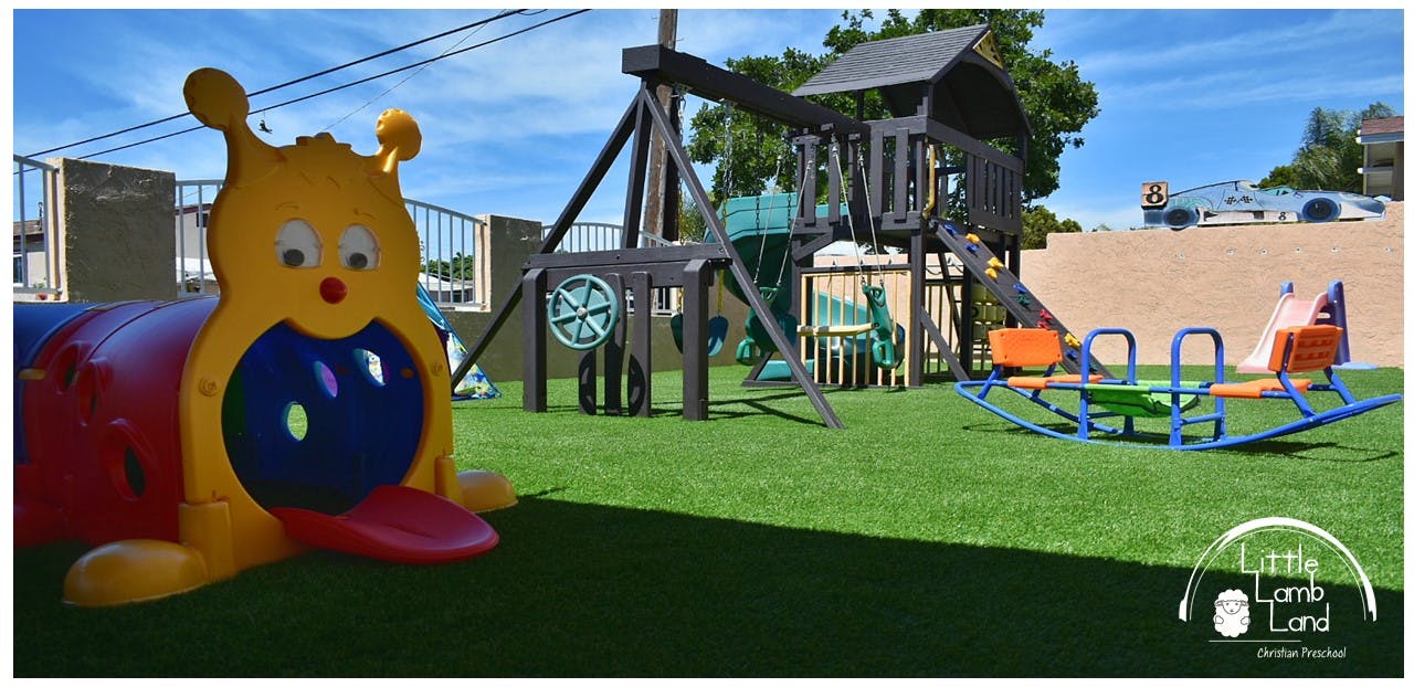 Playground with a caterpillar tunnel, swing set, and seesaw