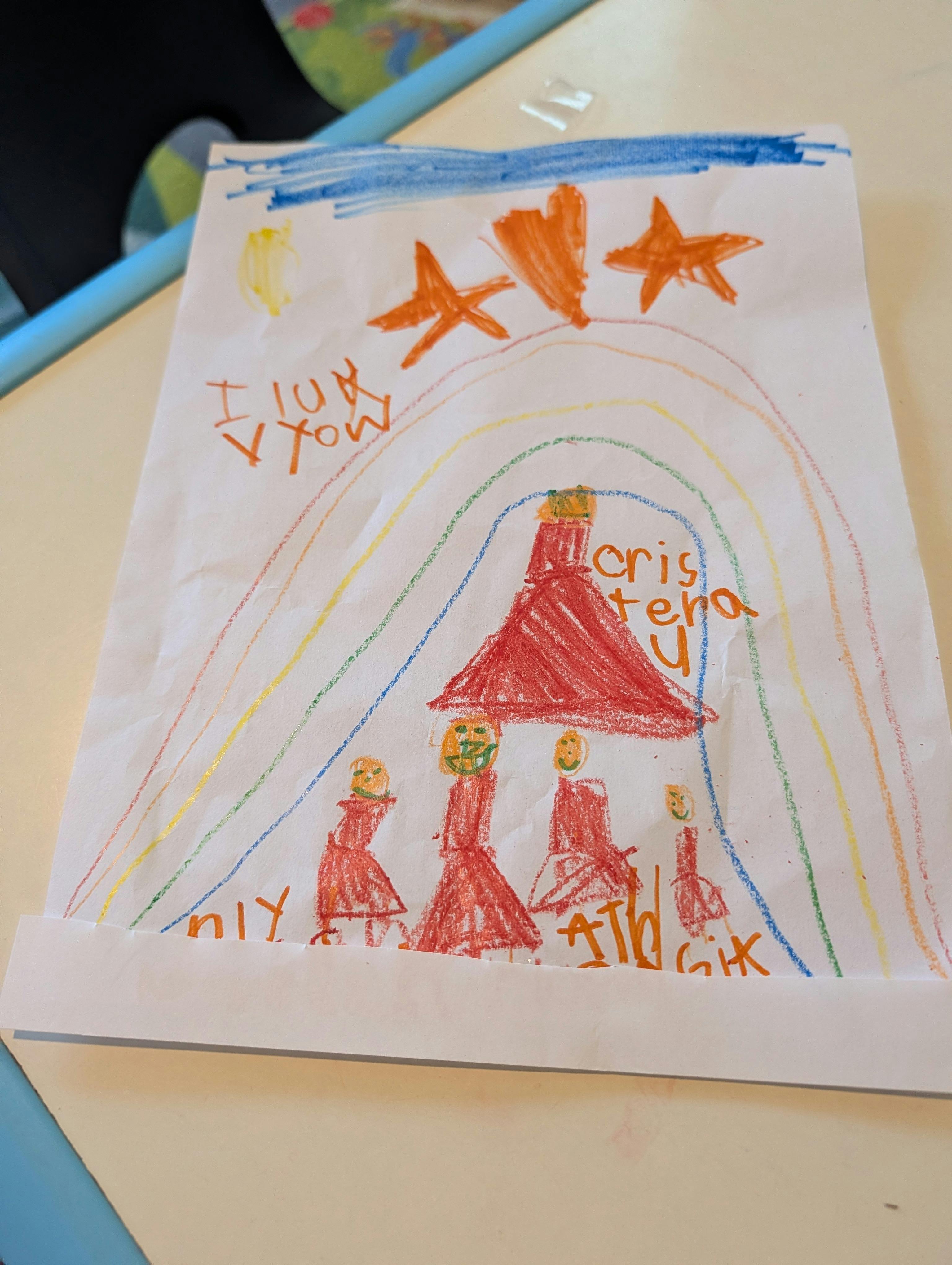 Child drawing of people under a rainbow and heart with written text