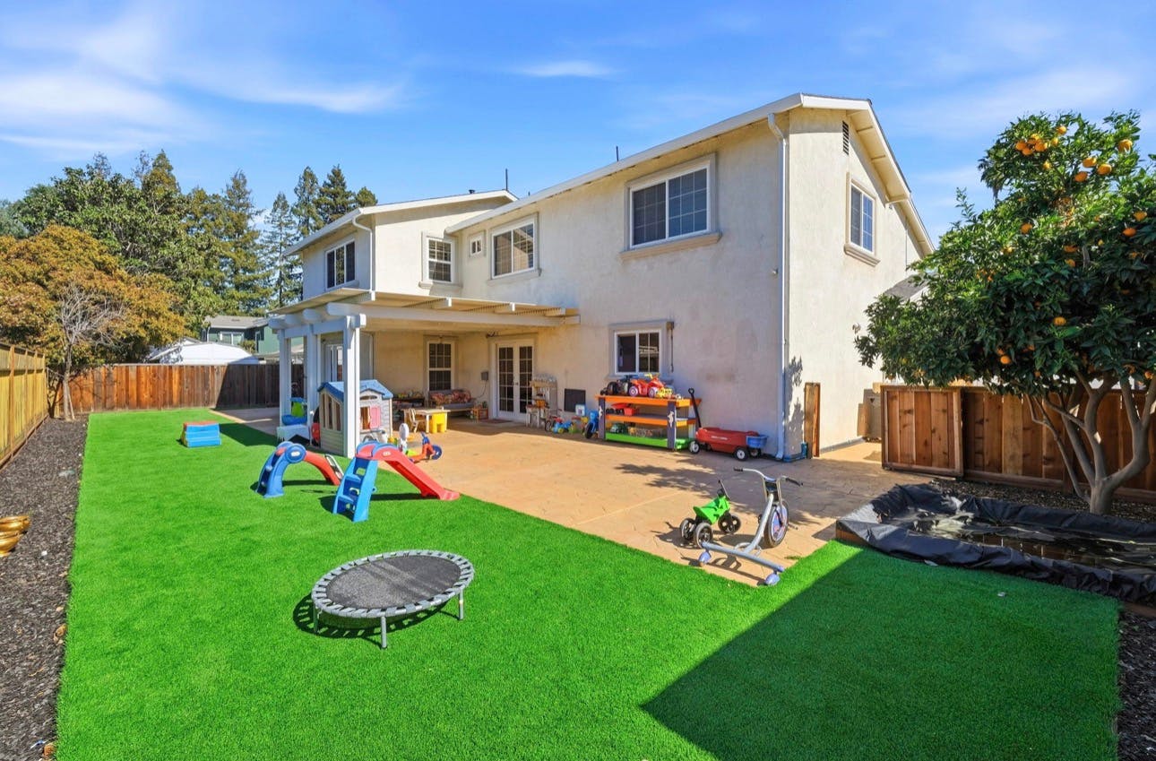 Backyard patio and lawn with children's play equipment