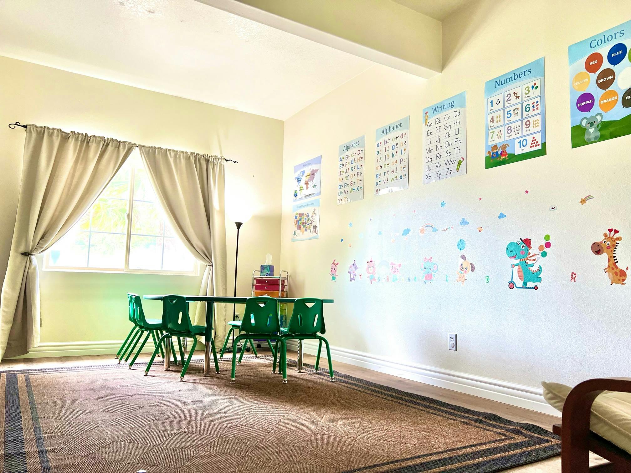 Children's classroom with small table and chairs, wall decorations