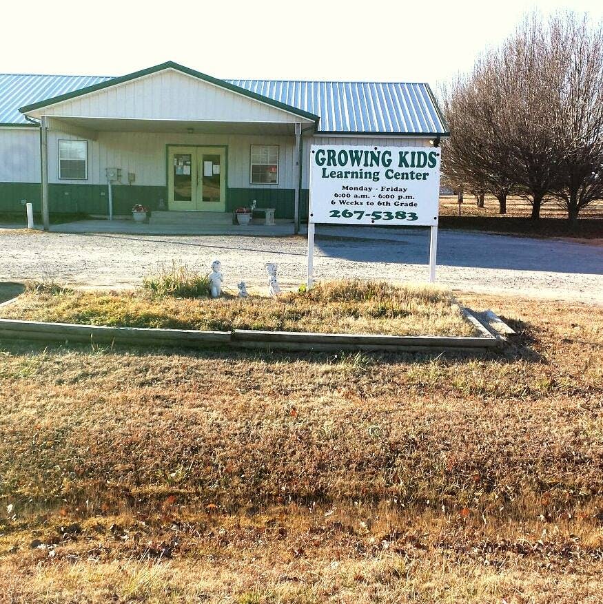 Building with a sign that reads "Growing Kids Learning Center"