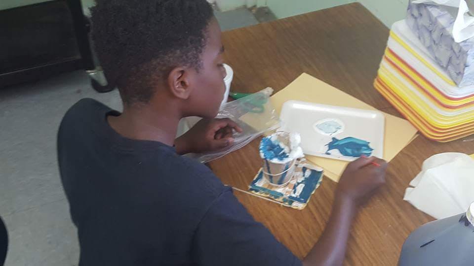Child at a table with art supplies