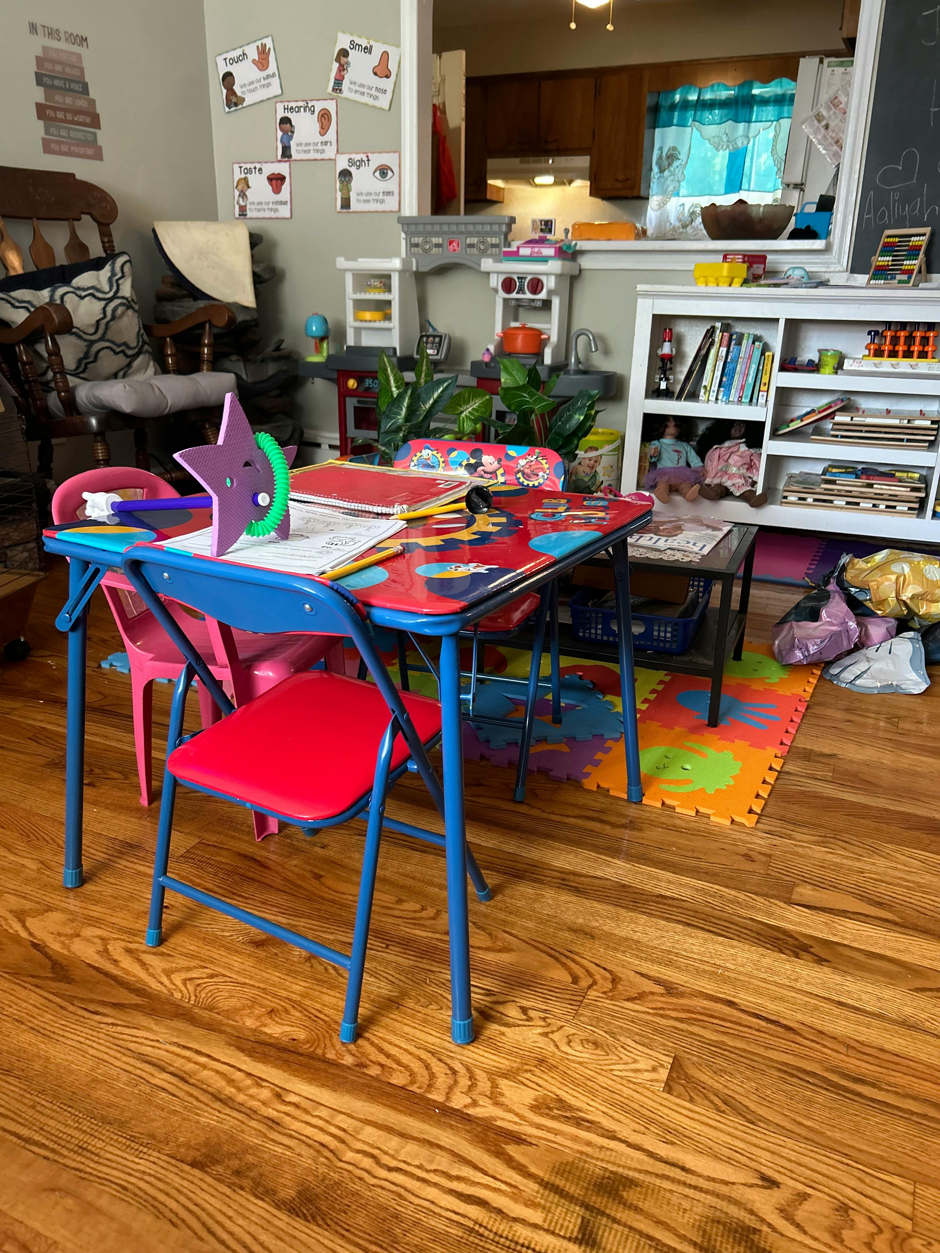 Children's table with chairs and toys in a room