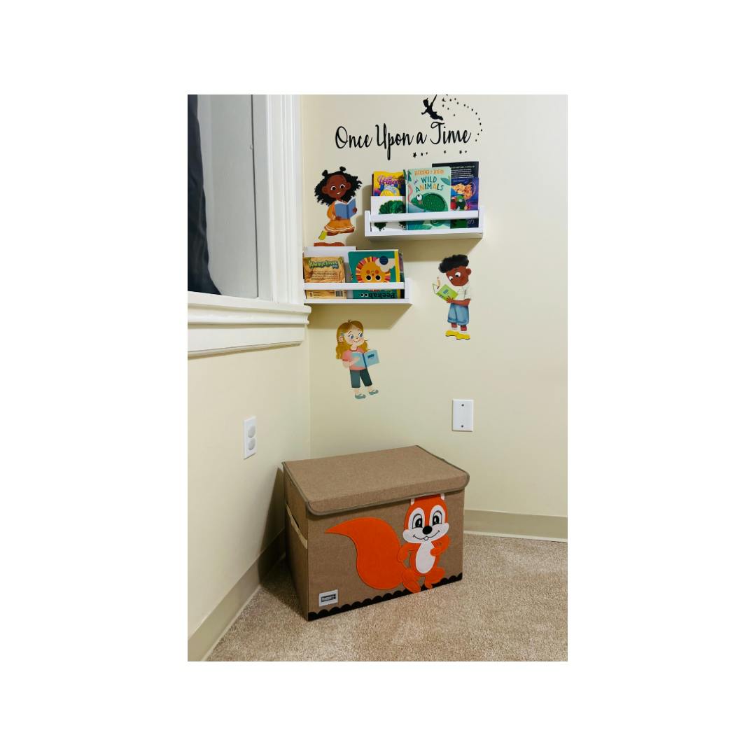 Wall with two shelves of books, child cutouts, and a toy box with a squirrel