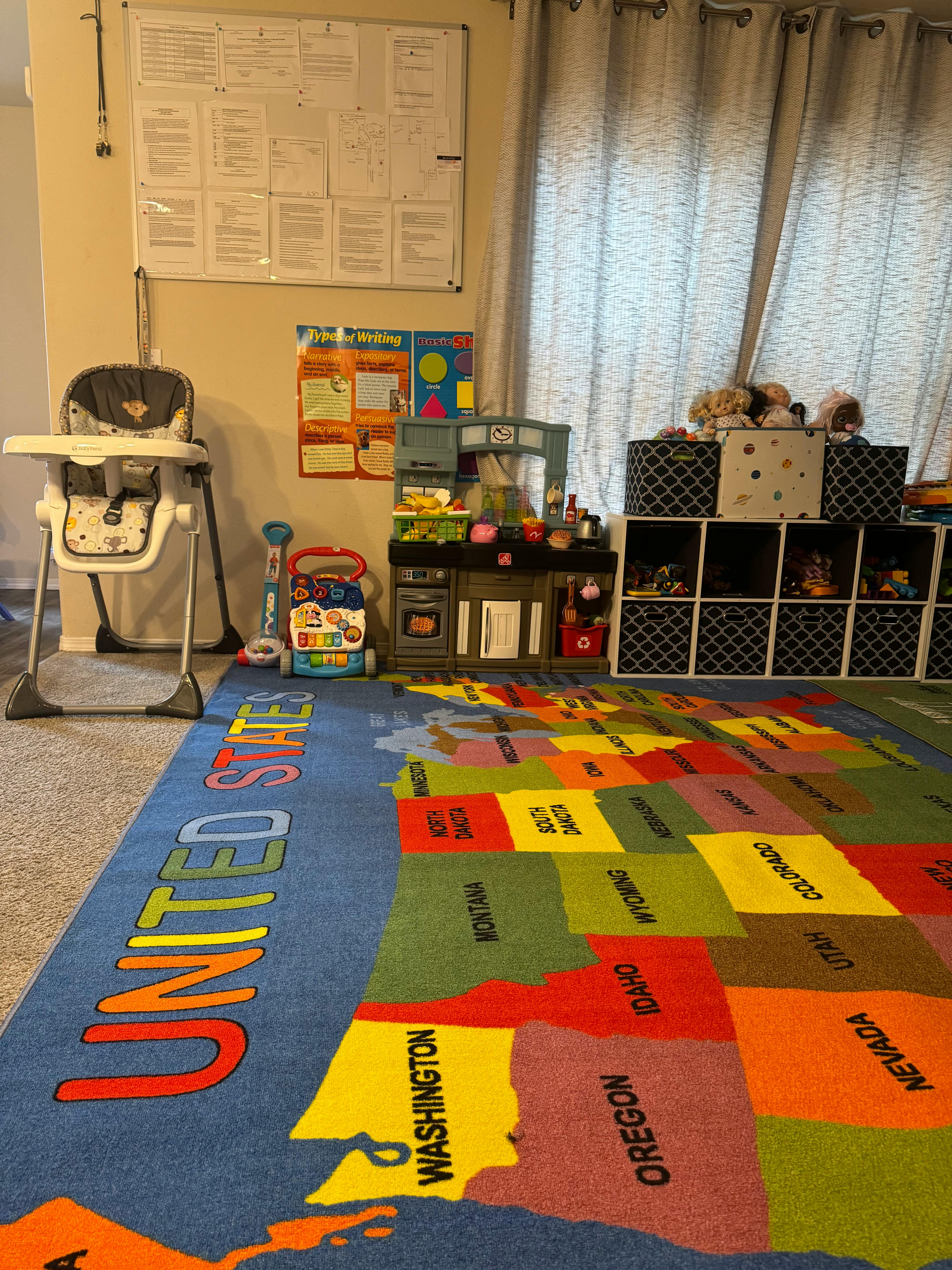 Playroom with a map of the United States on the floor, high chair, and toys