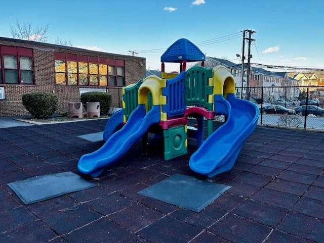 Playground with blue slides and colorful climbing structure