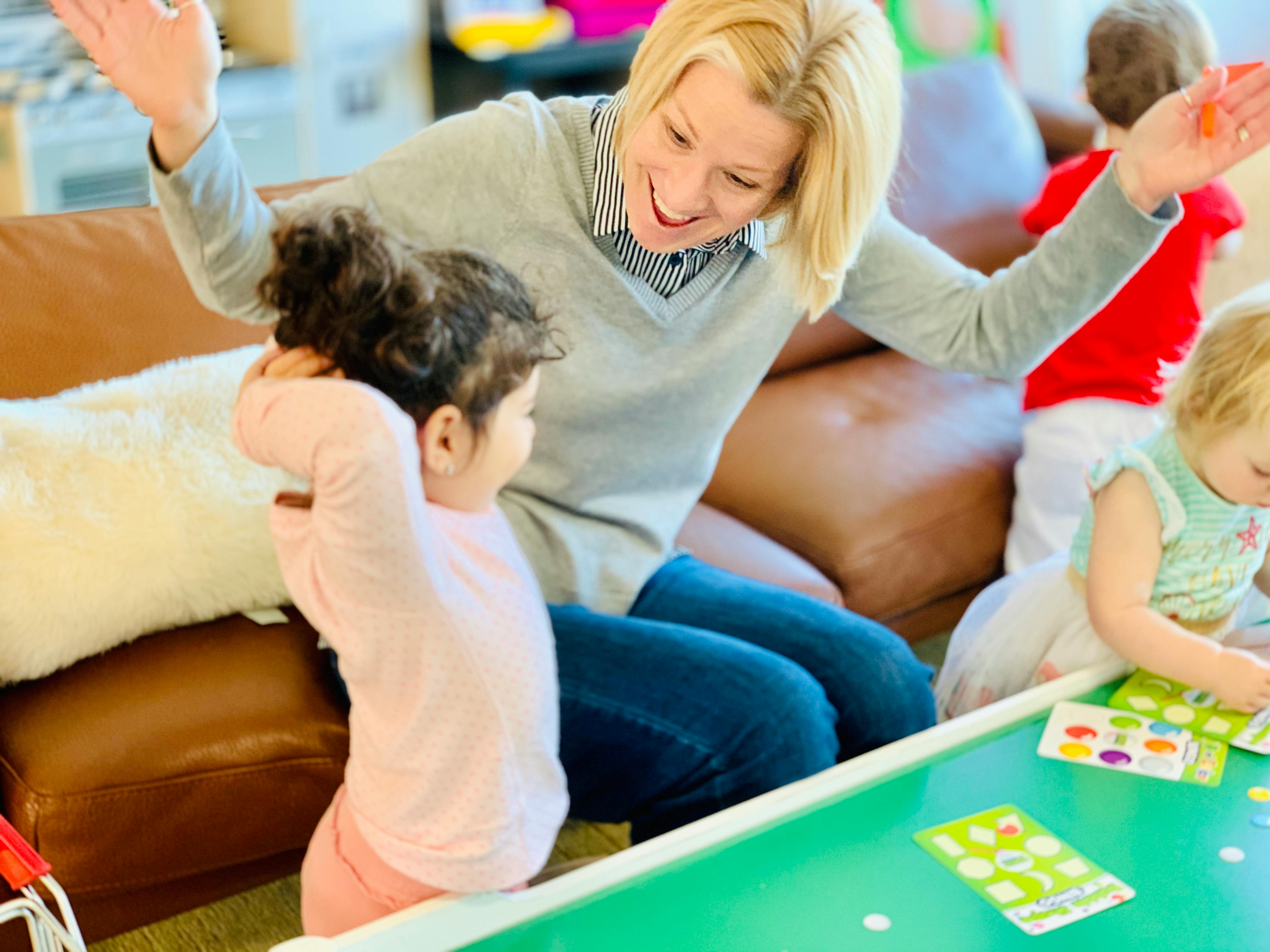 Adult and child playing a game at a table
