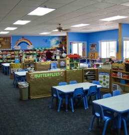 empty classroom with small tables and chairs