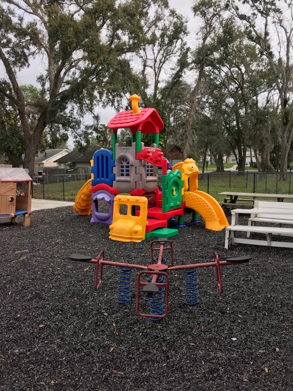 Colorful playground equipment with slides and a spring rider
