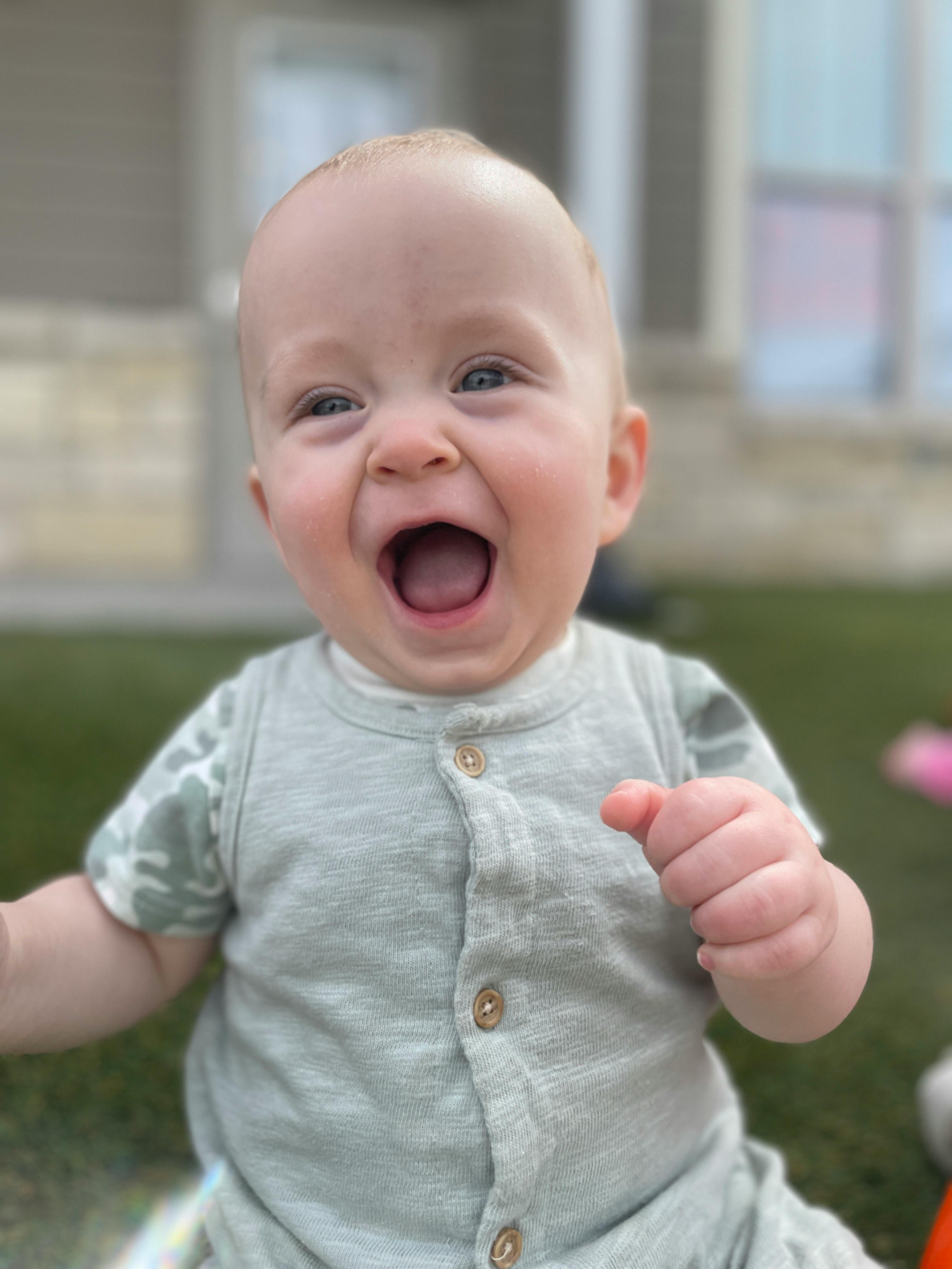 Child with mouth open, looking at camera