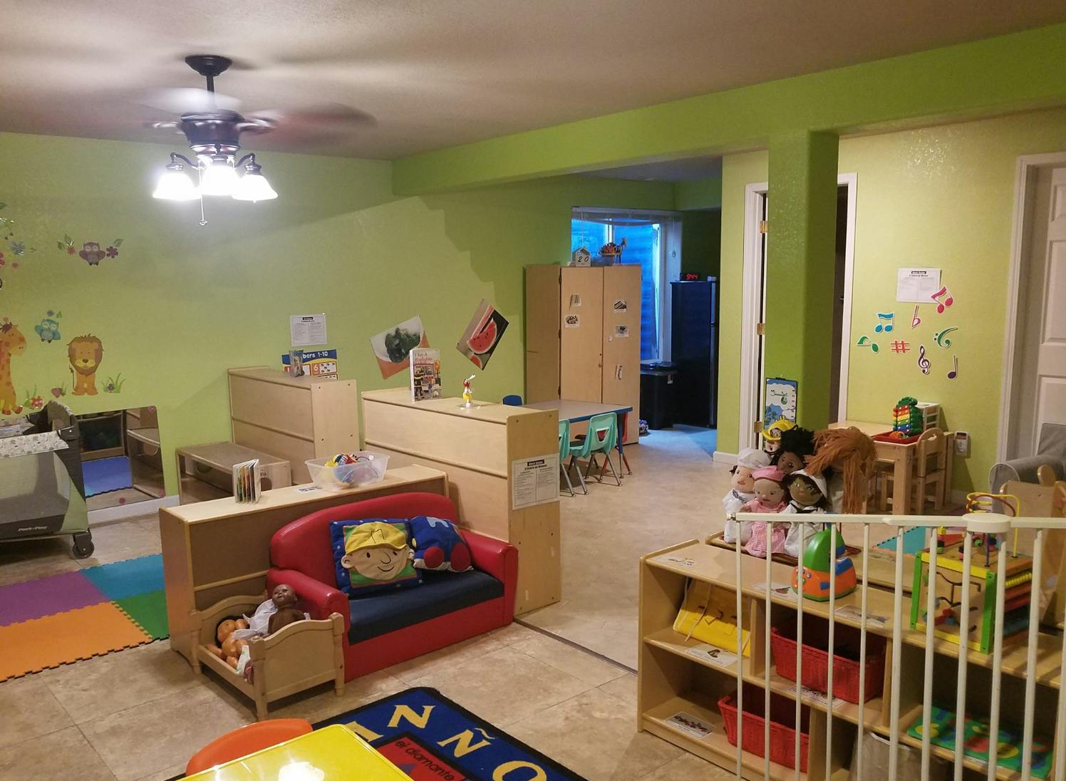 Playroom with various toys, furniture, and a crib