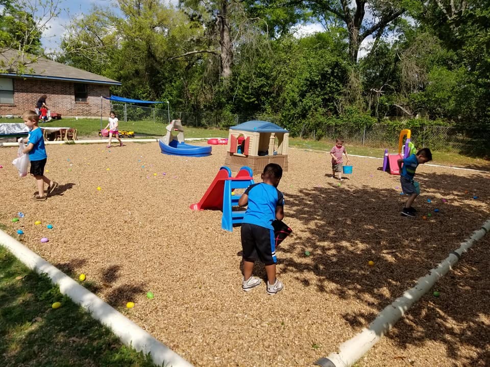 Children playing on a wood chip playground