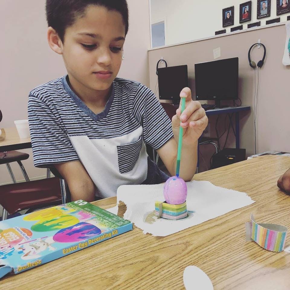 Child painting an egg