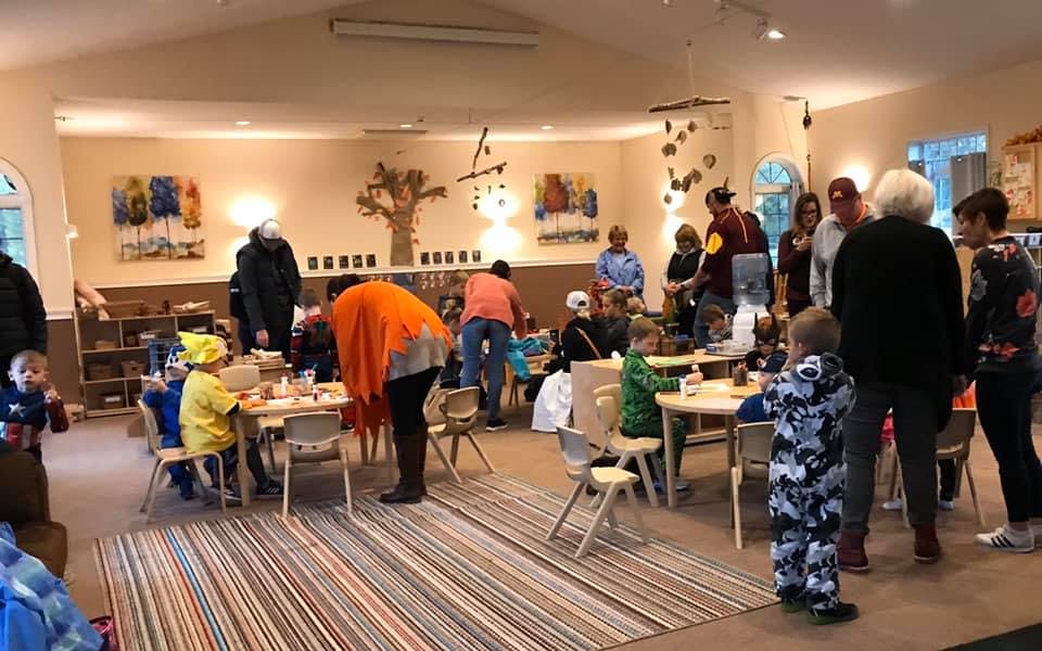People and children gathered in a large room