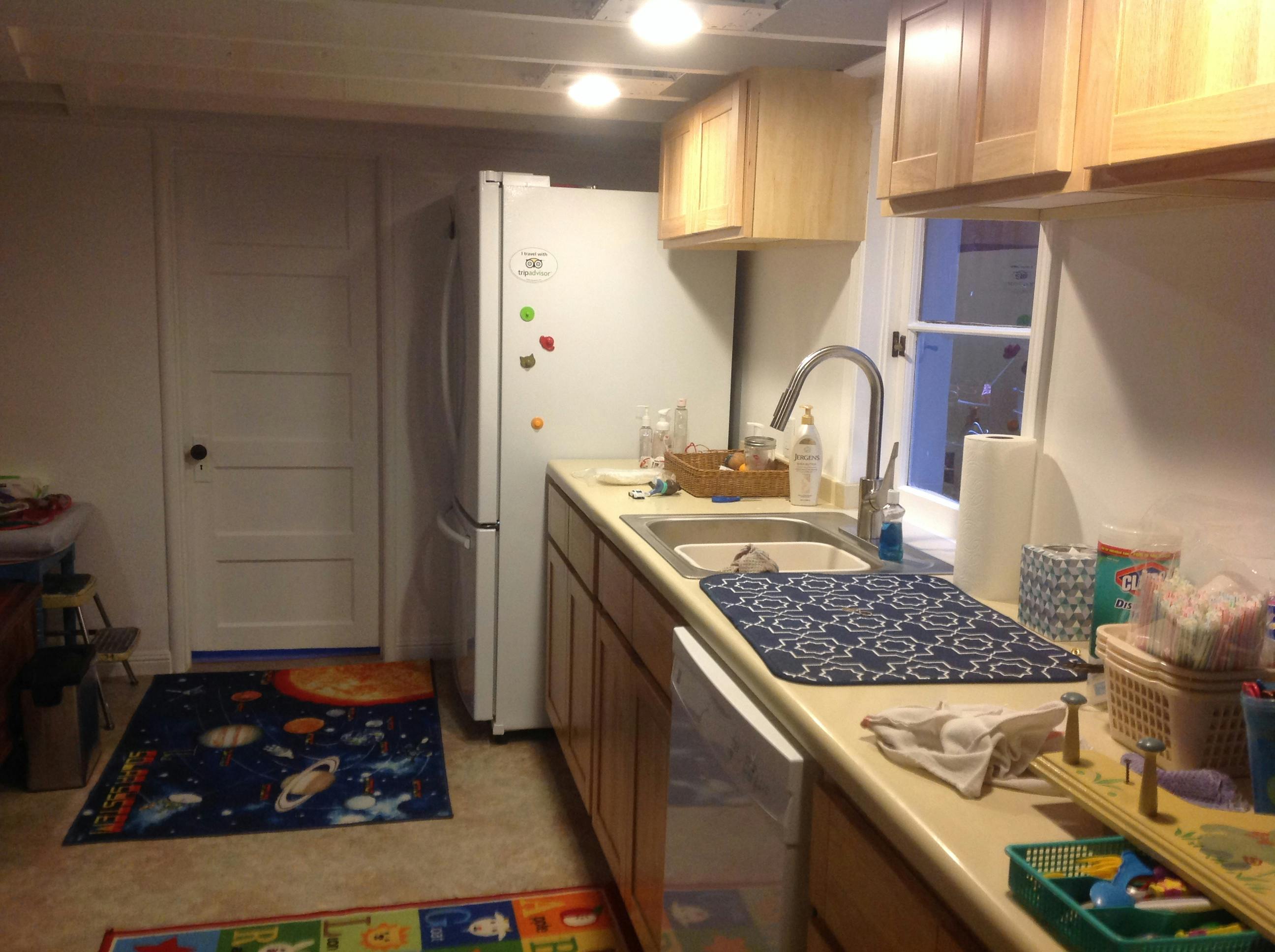 Kitchen counter with sink and refrigerator in a home setting