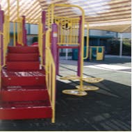 Red stairs and yellow railings on a playground structure