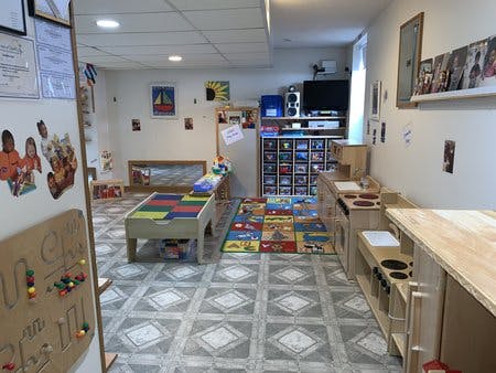 Playroom with a table, rug, and toy kitchen
