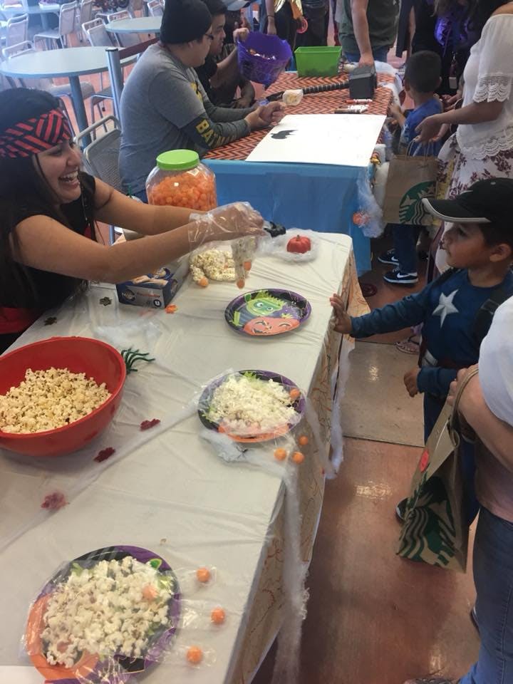Person serving popcorn to a child