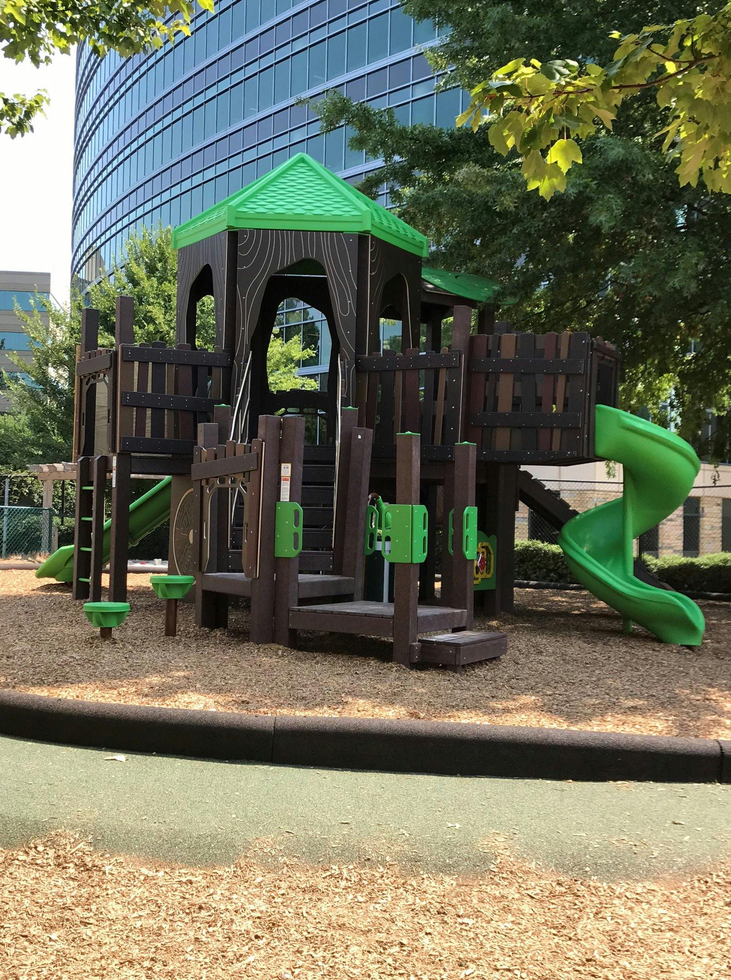 Playground structure with green roof and slides