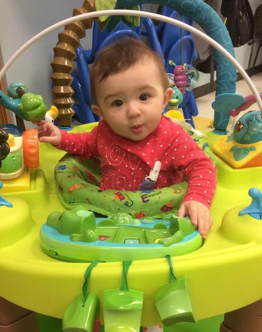 Child in a baby activity center