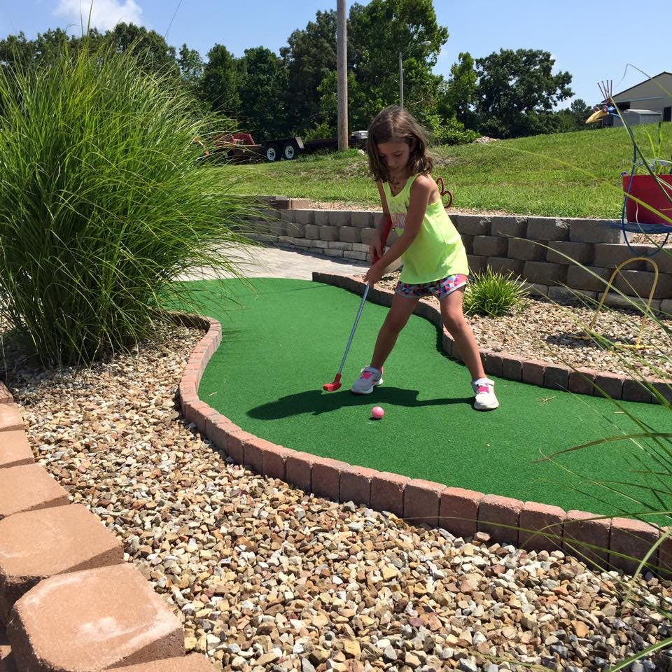 Child playing miniature golf