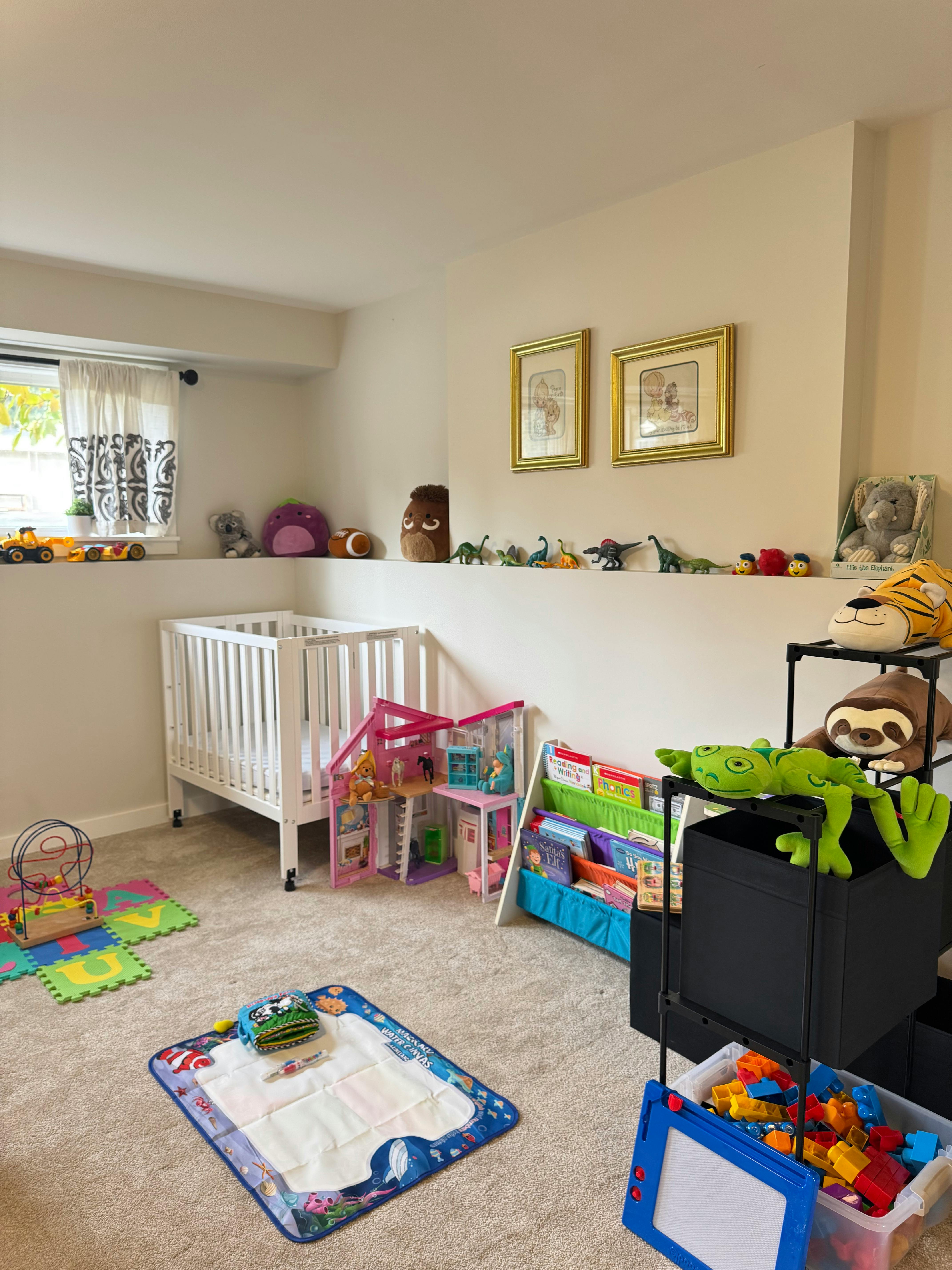 A child's room with a crib, toys, and books