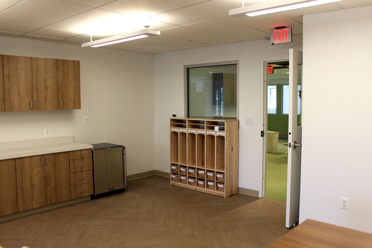 Empty room with wooden cabinets, counter, and cubby shelf