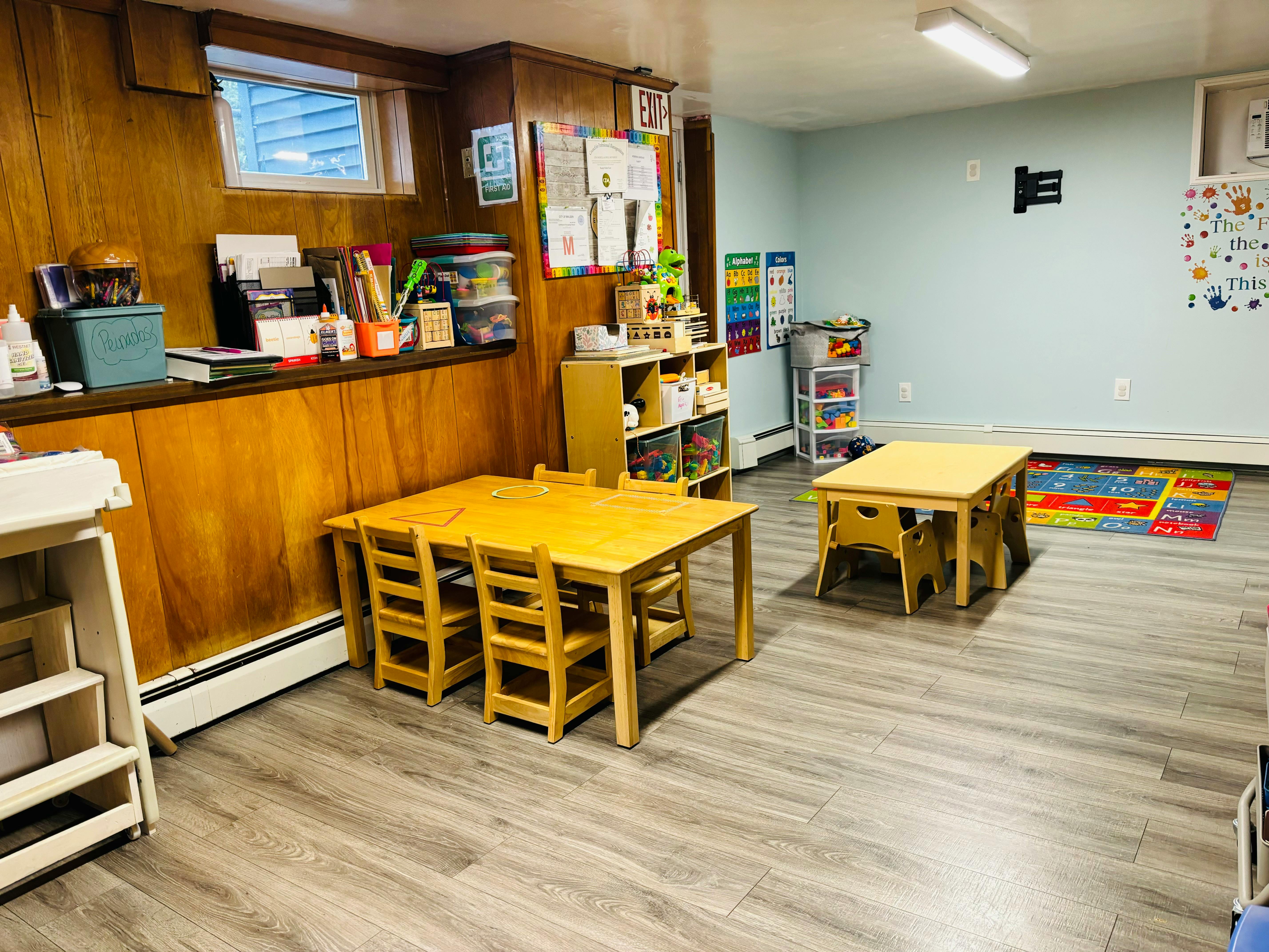 Classroom with small wooden tables and chairs