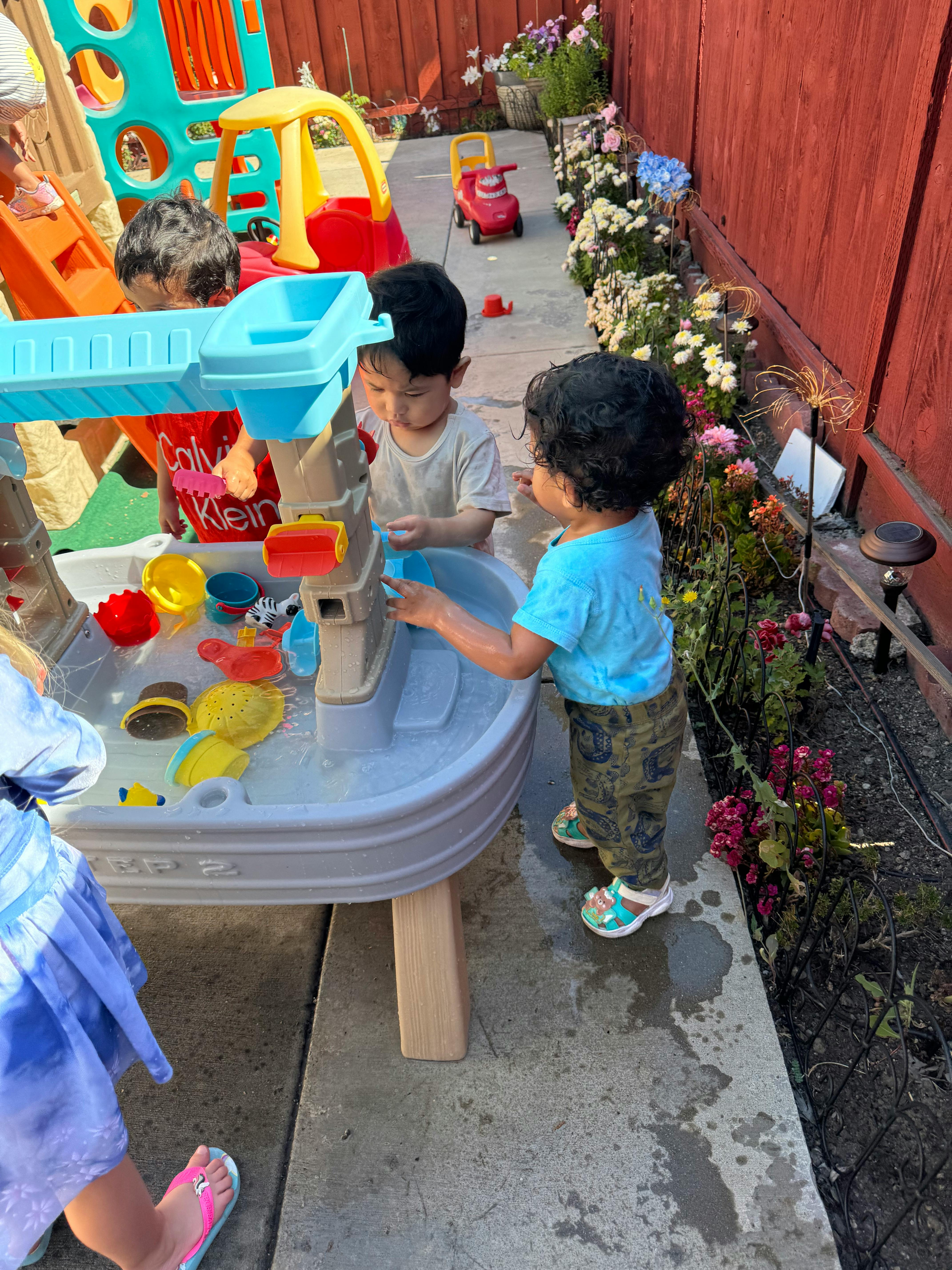 Children playing with a water table outdoors