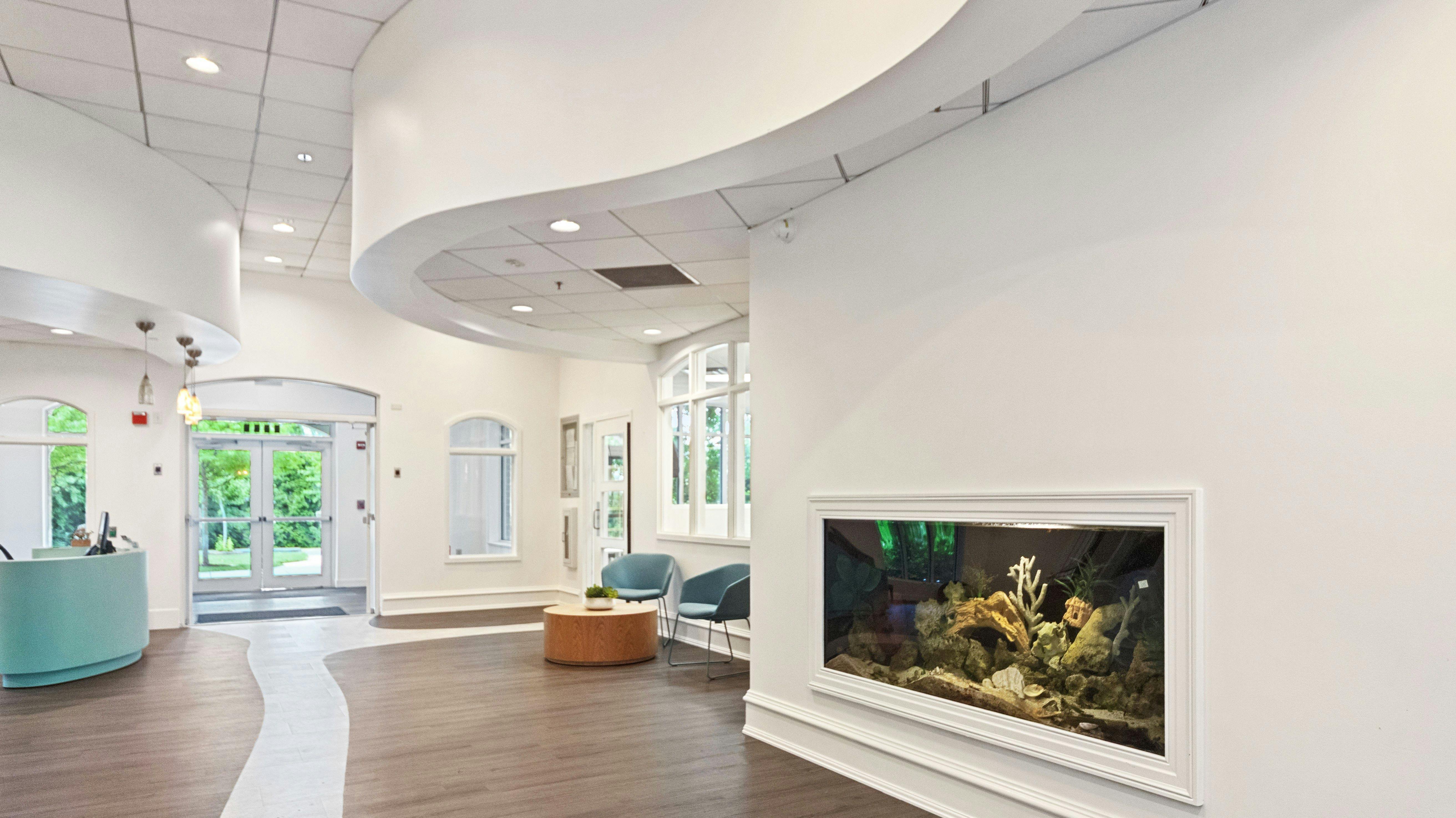 Lobby area with a curved reception desk and an embedded aquarium