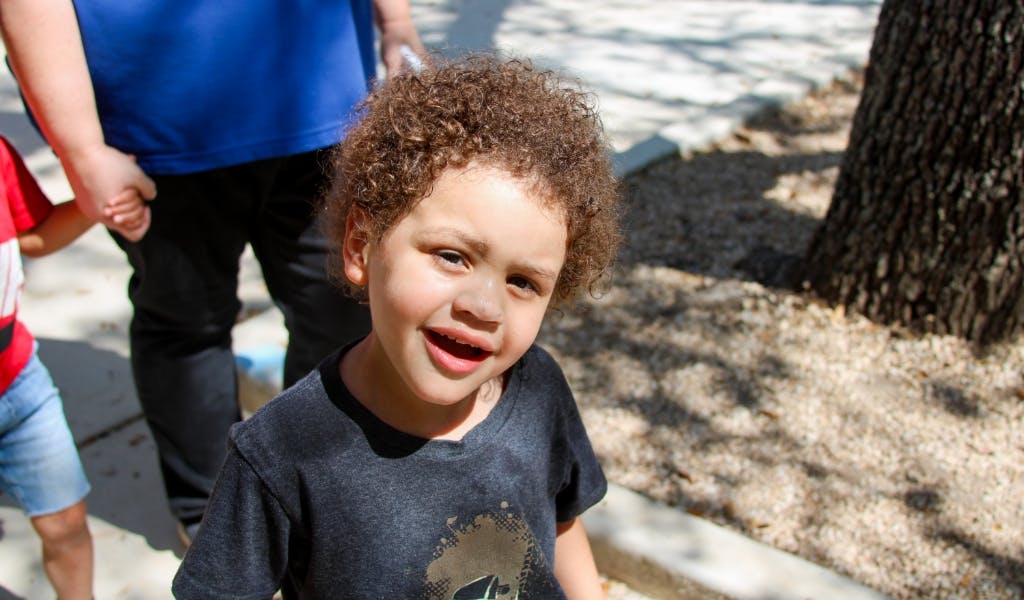 Child with curly hair looking up