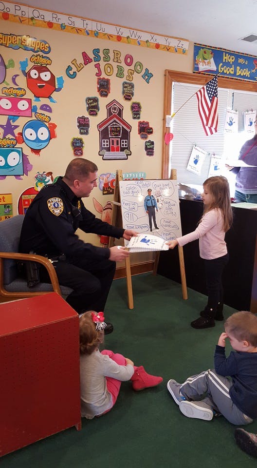 Police officer interacting with children in a classroom