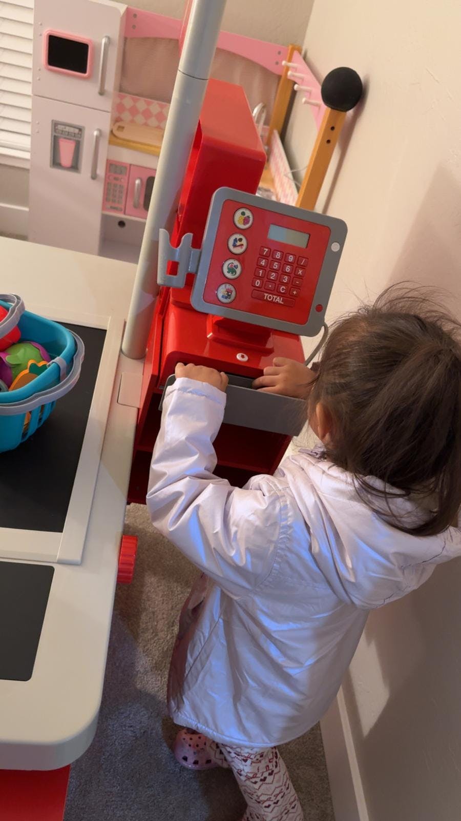Child playing with a toy cash register