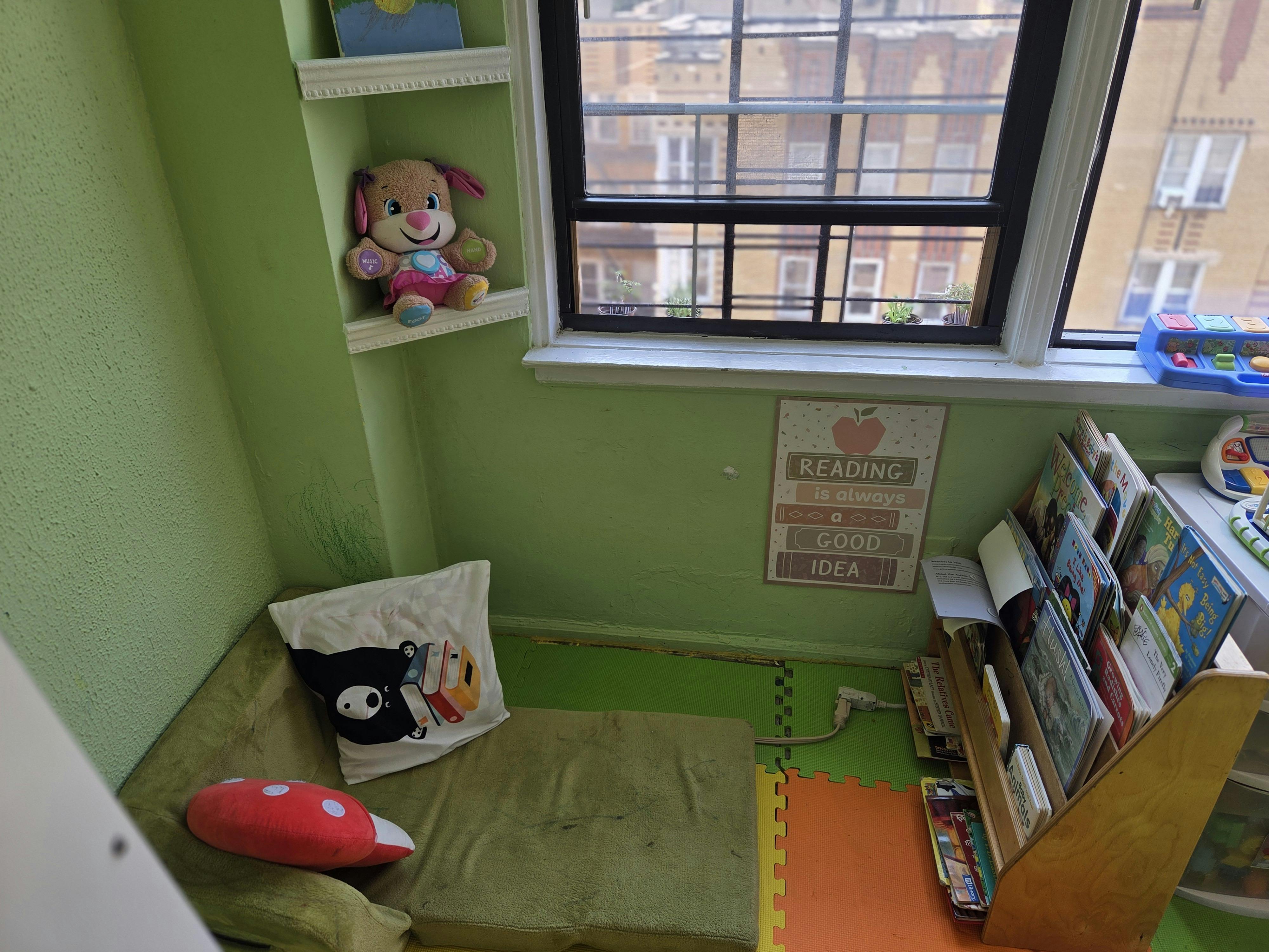 Reading nook with a window, stuffed animal, and books