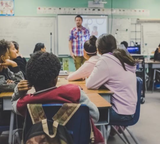 Teacher standing in front of a classroom of children