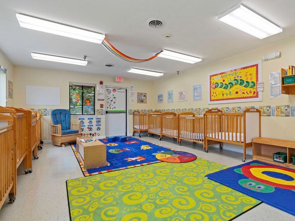 Cribs and colorful rugs in a nursery room